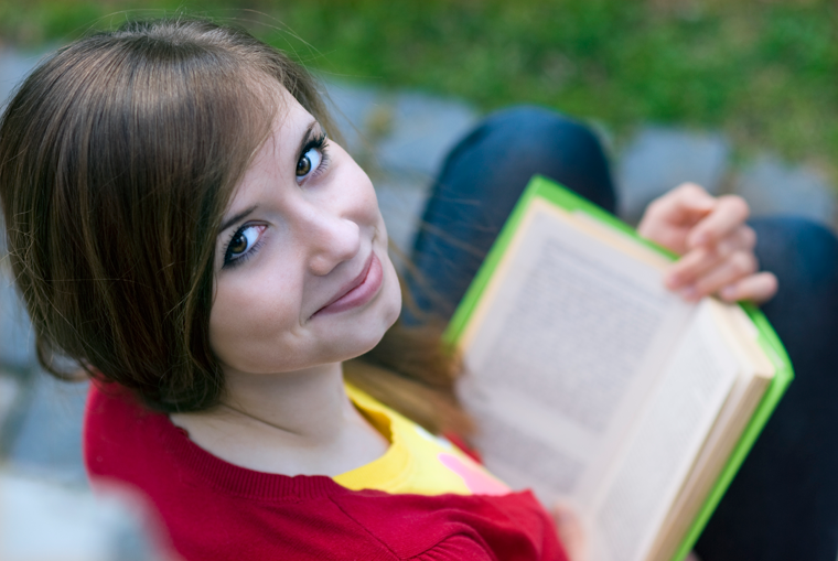 Woman Curls Up with an E-reader